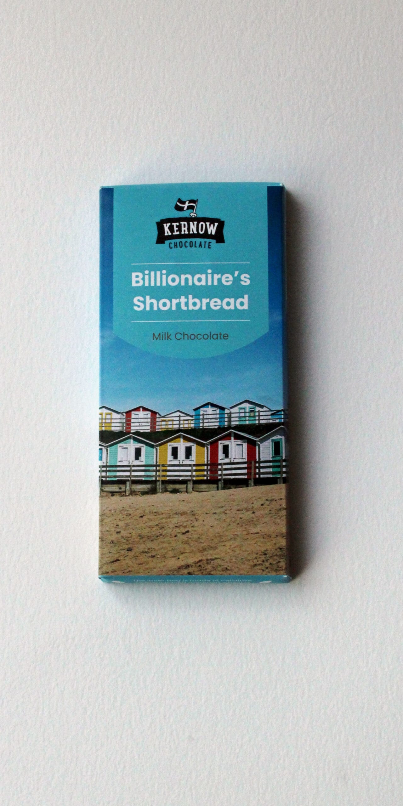 Billionaire's Shortbread chocolate bar packaging with a beach hut design and Kernow Chocolate branding.