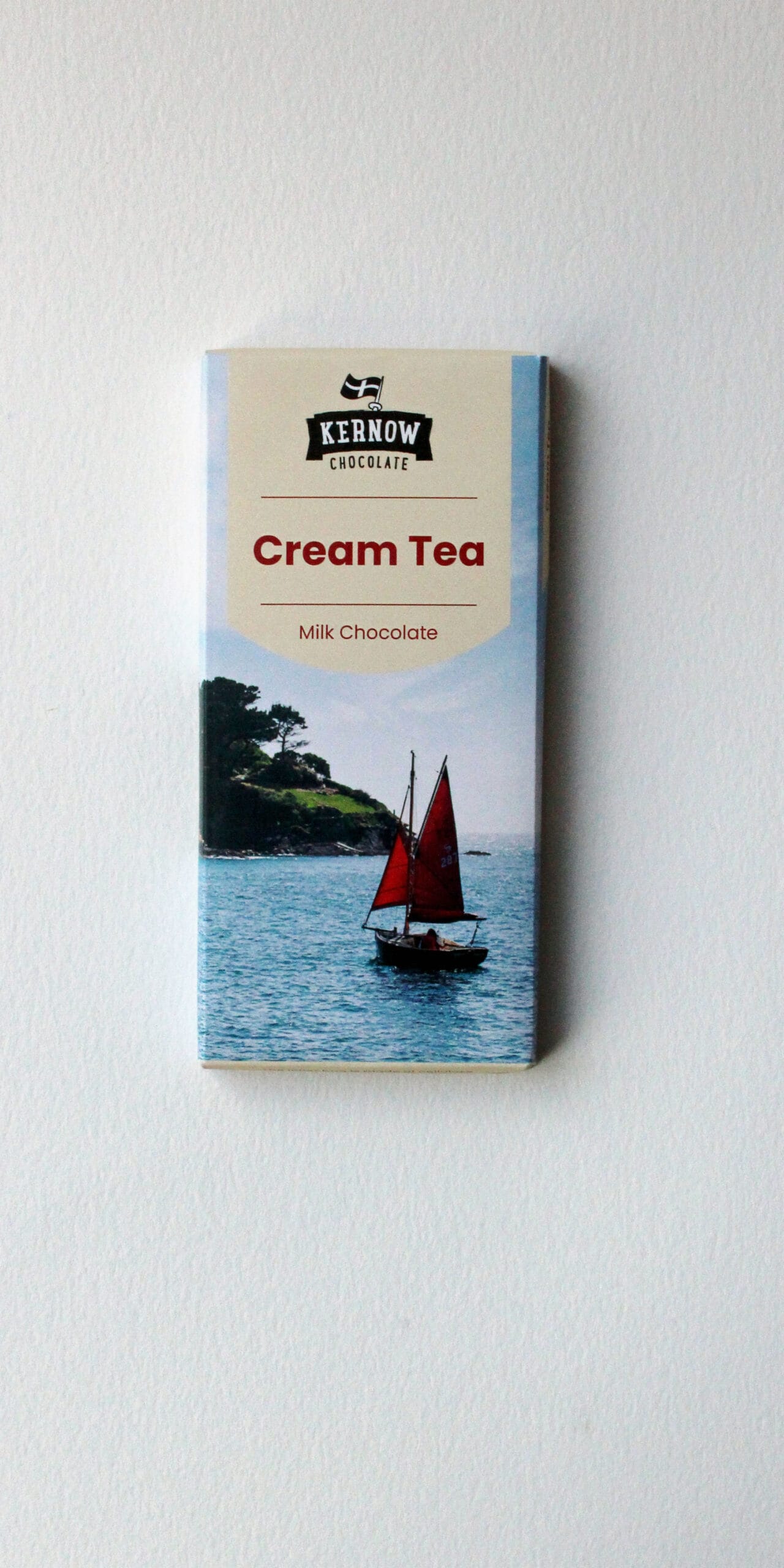 Kernow Chocolate's Cream Tea milk chocolate bar packaging featuring a sailing boat on water.