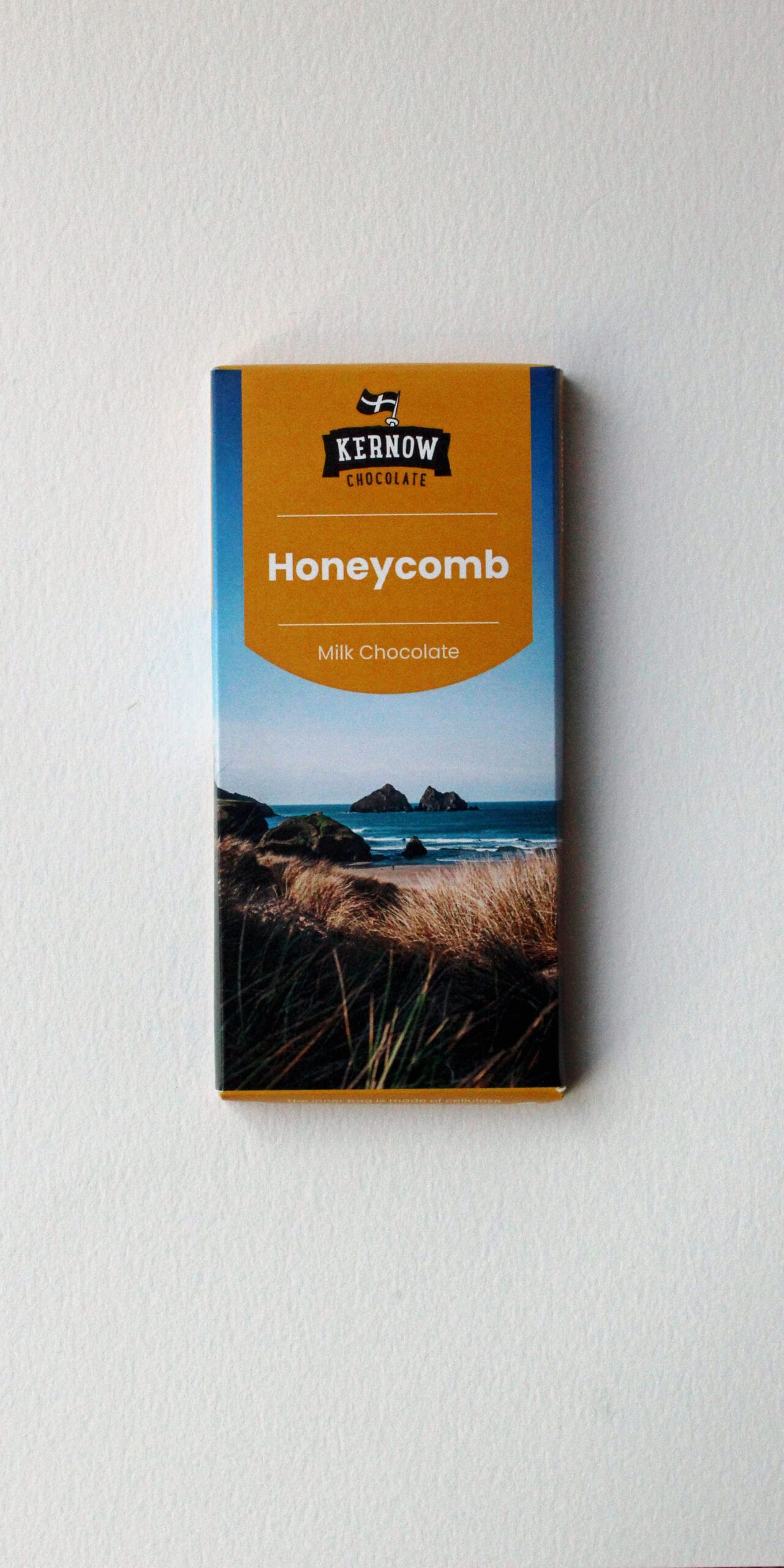 Kernow Chocolate honeycomb milk chocolate bar with a coastal landscape design on the packaging.