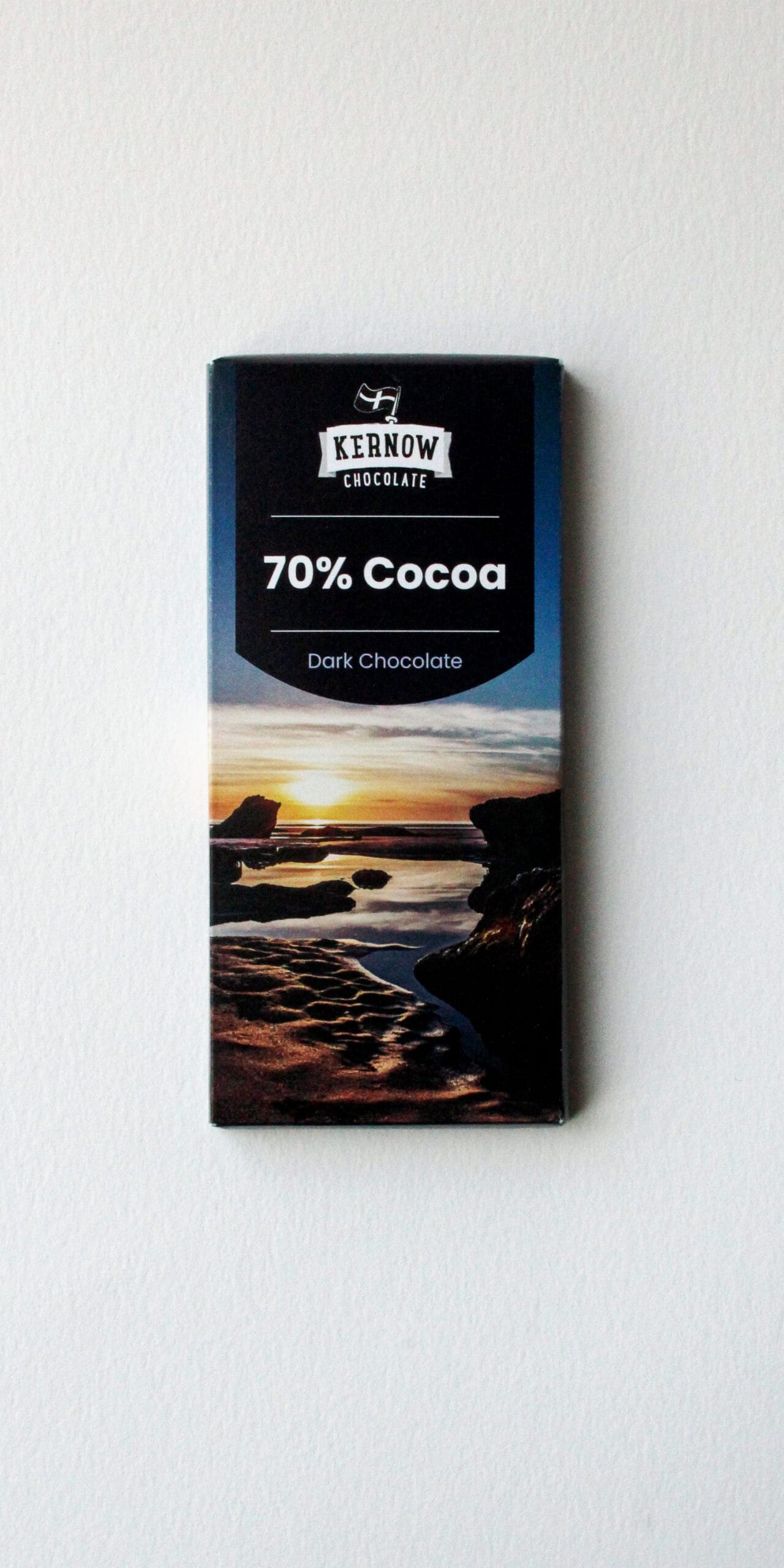 Kernow Chocolate 70% Cocoa dark chocolate bar with a coastal sunset image on the wrapper, set against a plain white background and visible branding.
